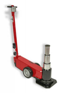 A red hydraulic floor jack is positioned upright with its lifting arm extended, isolated against a white background.