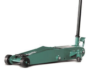 A green hydraulic floor jack with a handle, positioned idly on a white background.
