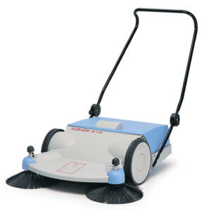 A manual push sweeper with dual rotating brushes, central collection bin, and upright handle, poised on a solid white background.