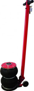 Red manual car jack with black lifting pads, upright, ready for use, against a plain background.